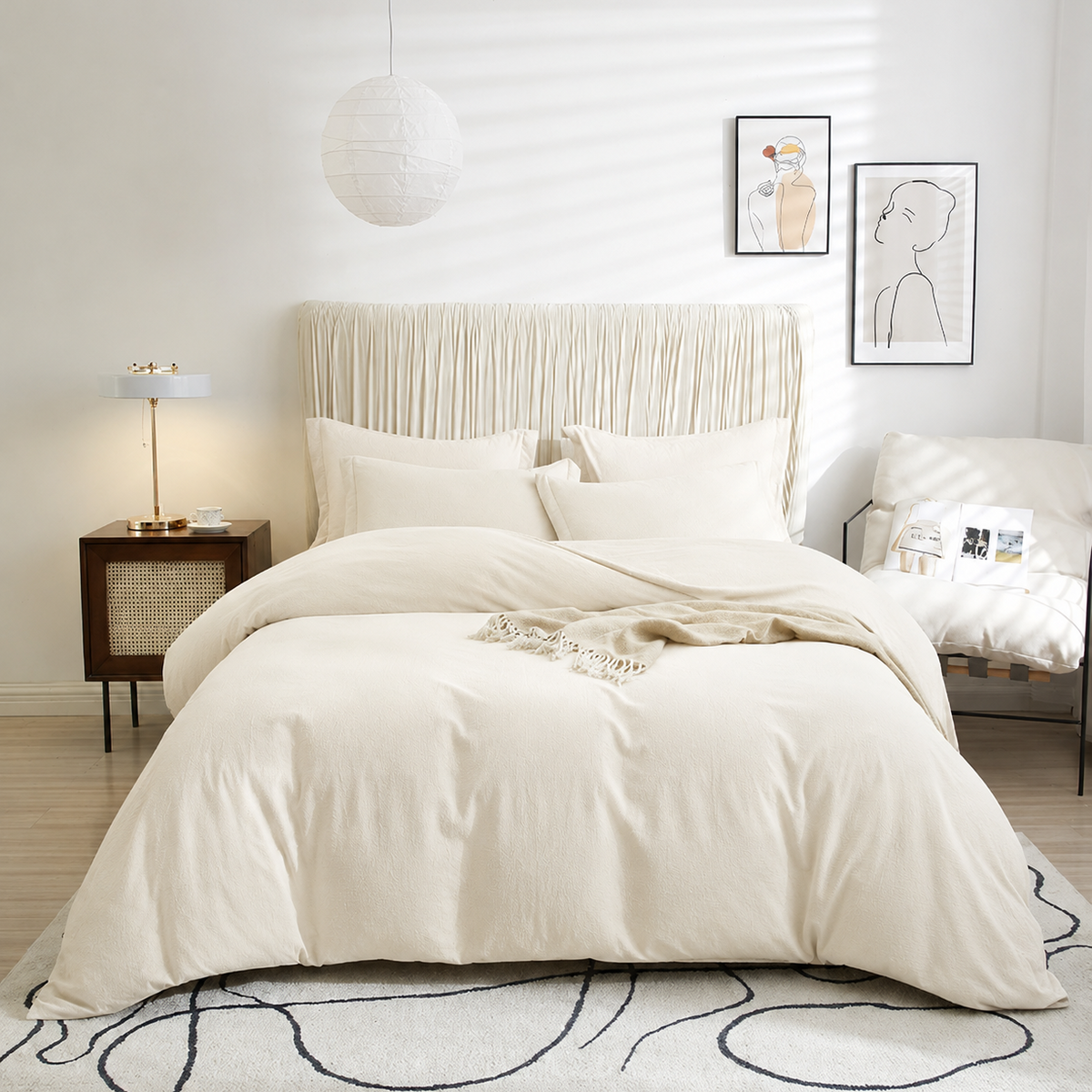 Neatly made bed with beige bedding in a modern bedroom setting.