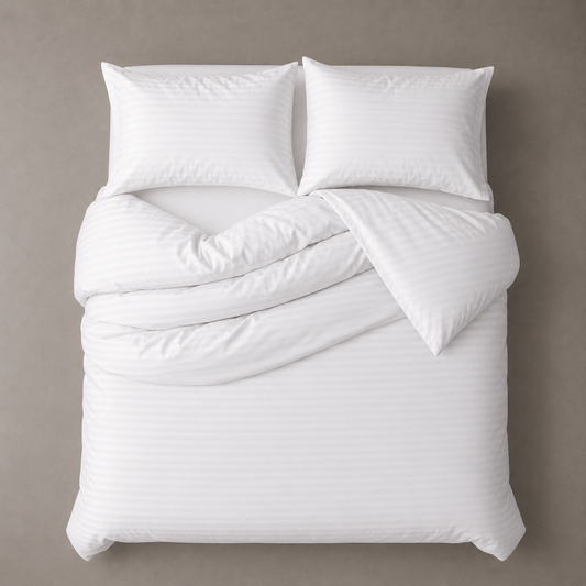 White comforter set with pillows on a beige background