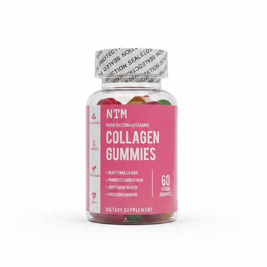 A hand holding a bottle of NITM Collagen Gummies with a pink label and white cap, with more bottles blurred in the background on a table.