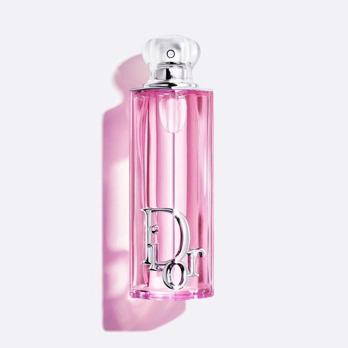Pink perfume bottle with silver cap on a light pink background