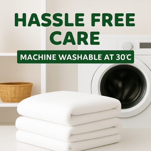 Stack of white towels with a washing machine in the background, emphasizing machine washable at 30°C.