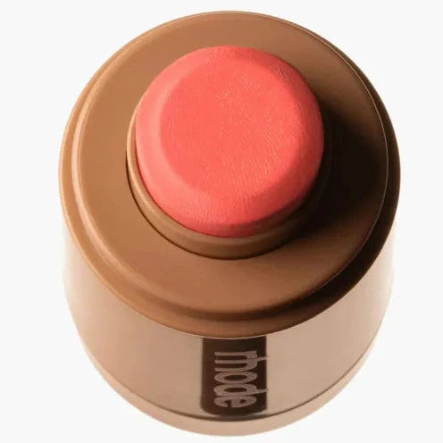 Makeup product with coral color on a white background