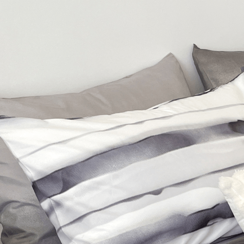 Single size, 4-piece, reversible duvet cover set featuring a striped design in a vibrant gray color.